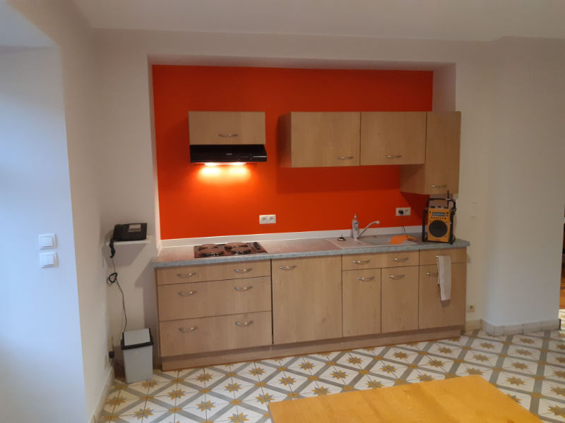 vue sur le plan de travaille d'une cuisine, mur du fond orange et contour blanc